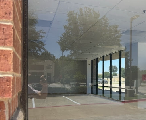 Spotless clean storefront glass window with clear reflections after Stream Clean Pros cleaning